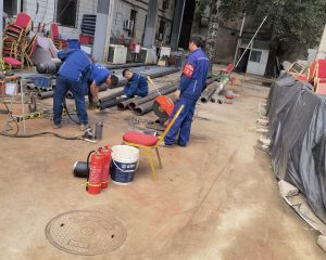 Workers laying gas pipeline on construction site