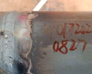 Welded steel gas pipe joint close-up