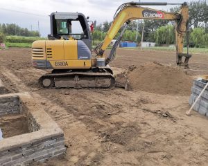 Excavator digging trench for gas pipeline